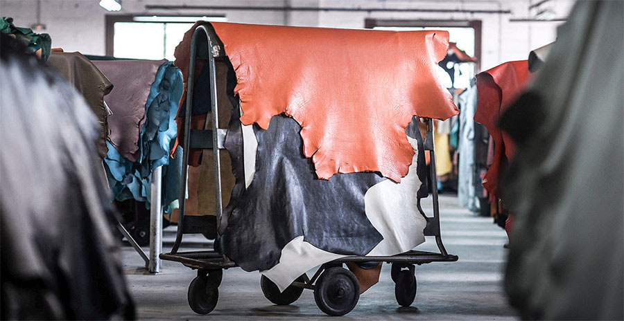 Leather hides hanging over a rack.